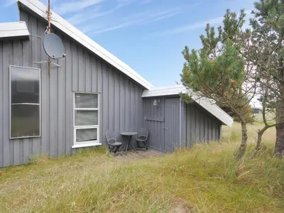 a house with a table and chairs in front of it at Holiday Home Dode - 225m from the sea by Interhome in Torsted
