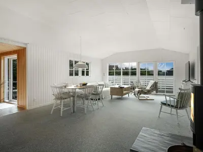a living room with a table and chairs at Holiday Home Kanerva - 350m from the sea by Interhome in Torsted