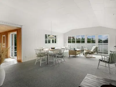 a living room with a table and chairs at Holiday Home Kanerva - 350m from the sea by Interhome in Torsted
