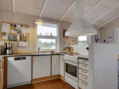 a kitchen with white appliances and a window at Holiday Home Tino - 900m from the sea by Interhome in Torsted