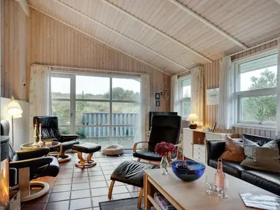 a living room with chairs and a couch and a table at Holiday Home Tino - 900m from the sea by Interhome in Torsted