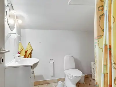 a bathroom with a toilet and a sink at Holiday Home Tino - 900m from the sea by Interhome in Torsted