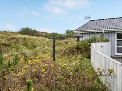a house on top of a hill next to a fence at Holiday Home Tino - 900m from the sea by Interhome in Torsted