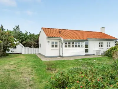 a white house with an orange roof at Holiday Home Meindor - 350m from the sea by Interhome in Torsted