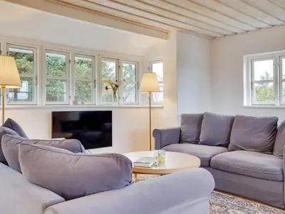 a living room with two couches and a tv at Holiday Home Meindor - 350m from the sea by Interhome in Torsted