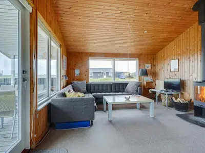 a living room with a couch and a table at Holiday Home Svea - 400m from the sea by Interhome in Torsted