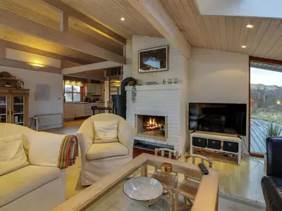 a living room with a couch and a fireplace at Holiday Home Essie - 250m from the sea by Interhome in Løkken