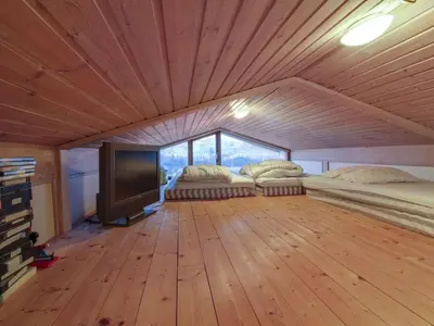 a room with two beds and a flat screen tv at Holiday Home Essie - 250m from the sea by Interhome in Løkken