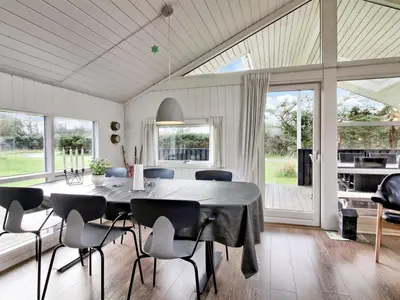 a dining room with a table and chairs at Holiday Home Annalisa - 1-2km from the sea by Interhome in Løkken