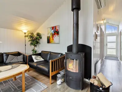 a living room with a fireplace and a couch at Holiday Home Annalisa - 1-2km from the sea by Interhome in Løkken
