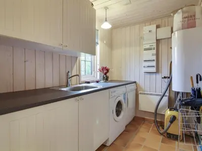 a kitchen with a sink and a washing machine at Holiday Home Jo - 1-2km from the sea by Interhome in Løkken