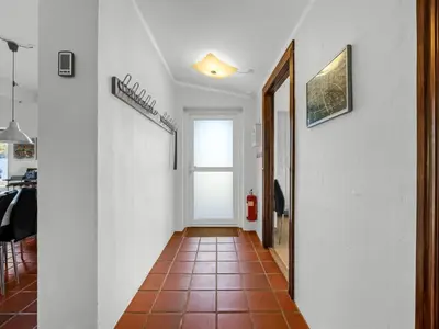 a hallway with white walls and a tile floor at Holiday Home Lenni - 700m from the sea by Interhome in Løkken