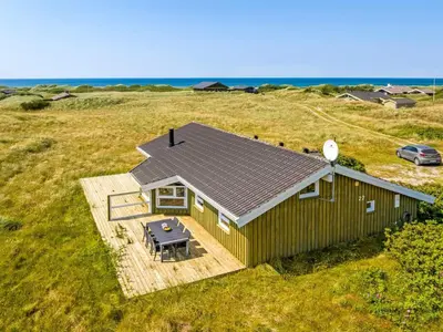 an overhead view of a small house with a picnic table at Holiday Home Katla - 400m from the sea by Interhome in Løkken
