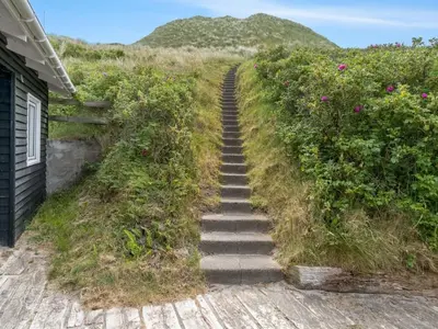 a set of stairs leading up to a house at Holiday Home Thorfrid - 150m from the sea by Interhome in Løkken