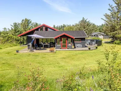 a home with a large yard with a house at Holiday Home Gullborg - 800m from the sea by Interhome in Løkken