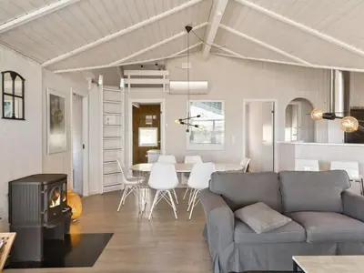 a living room with a couch and a table at Holiday Home Solvejg - 150m from the sea by Interhome in Løkken