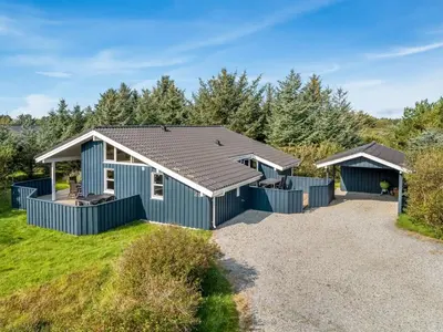 a holiday house with a pitched roof at Holiday Home Terho - 1km from the sea by Interhome in Løkken