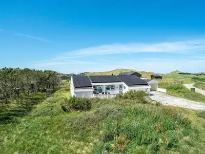 a house with solar panels on it in a field at Holiday Home Gorica - 450m from the sea by Interhome in Løkken
