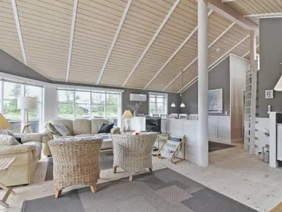 a living room with a couch and a table at Holiday Home Jens - 425m from the sea by Interhome in Løkken