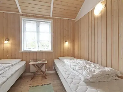 a room with two beds and a window in it at Holiday Home Jens - 425m from the sea by Interhome in Løkken
