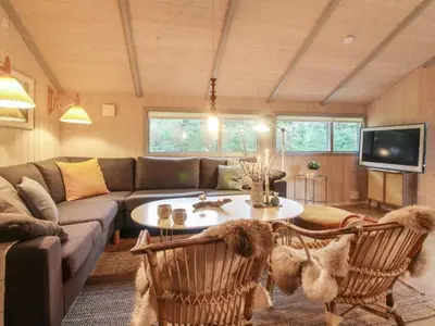 a living room with a couch and a table at Holiday Home Lovisa - 500m from the sea by Interhome in Løkken