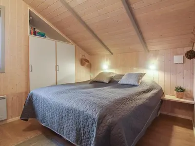 a bedroom with a large bed in a room at Holiday Home Lovisa - 500m from the sea by Interhome in Løkken