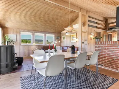 a dining room with a table and chairs at Holiday Home Estefania - 450m from the sea by Interhome in Løkken