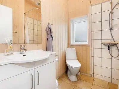 a bathroom with a sink and a toilet at Holiday Home Nynke - 600m from the sea by Interhome in Løkken