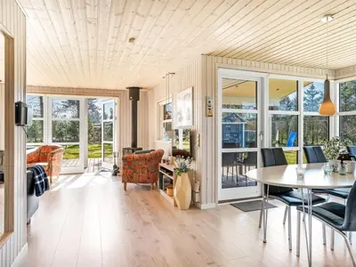 a dining room with a table and chairs at Holiday Home Troels - 750m from the sea by Interhome in Løkken