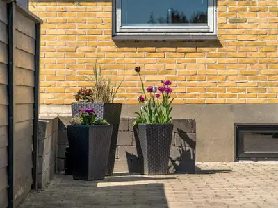 three flower pots sitting on the side of a building at Holiday Home Nayeli - 275m from the sea by Interhome in Løkken