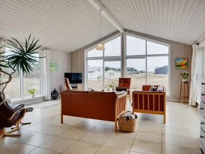a living room with a couch and a table at Holiday Home Elco - 450m from the sea by Interhome in Løkken