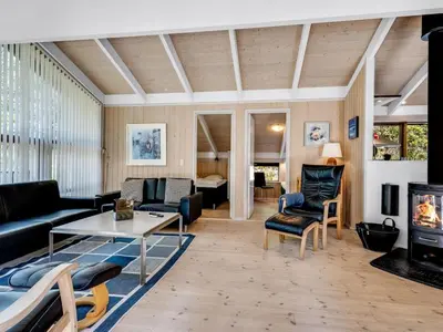 a living room with a couch and a table at Holiday Home Paulette - 450m from the sea by Interhome in Løkken