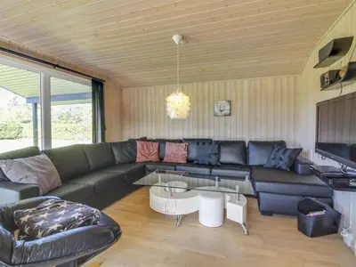 a living room with a couch and a table at Holiday Home Susan - 600m from the sea by Interhome in Løkken