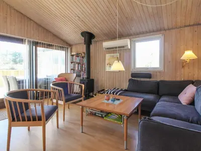 a living room with a couch and a table at Holiday Home Taina - 1-1km from the sea by Interhome in Løkken