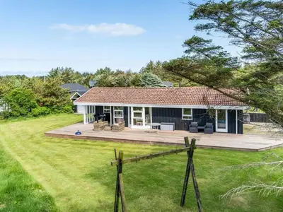a home with a large yard and a house at Holiday Home Klakke - 900m from the sea by Interhome in Løkken