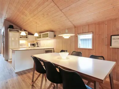 a kitchen and dining room with a table and chairs at Holiday Home Elsemaria - 1-3km from the sea by Interhome in Løkken