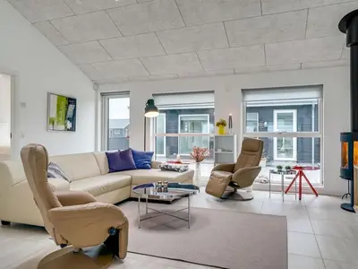 a living room with a couch and two chairs at Holiday Home Eveline - 1-5km from the sea by Interhome in Løkken