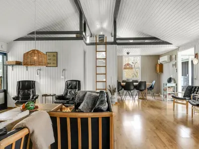 a living room with a couch and chairs at Holiday Home Lempi - 300m from the sea by Interhome in Løkken