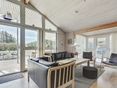 a living room with a table and chairs at Holiday Home Sonke - 500m from the sea by Interhome in Løkken