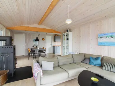 a living room with a couch and a table at Holiday Home Marino - 480m from the sea by Interhome in Løkken