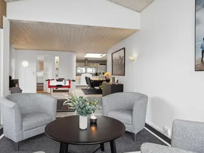 a living room with chairs and a table at Holiday Home Frethi - 350m from the sea by Interhome in Blokhus