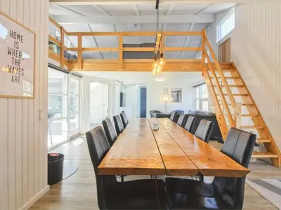 a dining room with a wooden table and chairs at Holiday Home Yessica - 300m from the sea by Interhome in Løkken