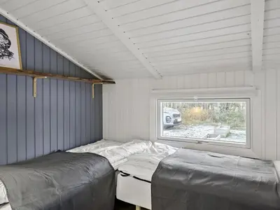 a bedroom with two beds and a window at Holiday Home Yessica - 300m from the sea by Interhome in Løkken