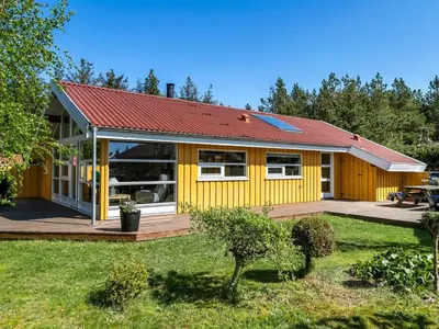 a yellow house with a red roof at Holiday Home Vetle - 2-8km from the sea by Interhome in Blokhus