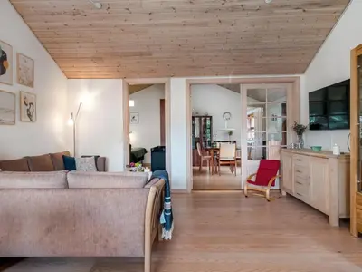 a living room with a couch and a table at Holiday Home Vetle - 2-8km from the sea by Interhome in Blokhus