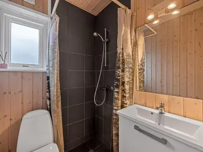 a bathroom with a shower and a toilet and a sink at Holiday Home Elenore - 900m from the sea by Interhome in Løkken