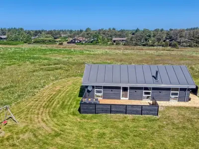 a small house in a field of grass at Holiday Home Elenore - 900m from the sea by Interhome in Løkken