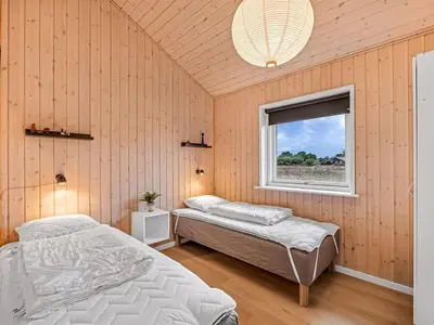 a bedroom with two beds and a window at Holiday Home Elenore - 900m from the sea by Interhome in Løkken