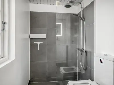 a bathroom with a shower and a toilet at Holiday Home Wiebke - 200m from the sea by Interhome in Blokhus