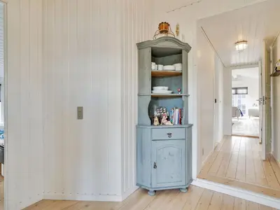 a blue cabinet in a room with a hallway at Holiday Home Wiebke - 200m from the sea by Interhome in Blokhus